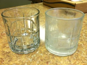 This picture illustrates what happens when hard water impacts your home. On the right, the glass is clear. On the left, the glass has run through the dishwasher, but is still coated by calcium and magnesium deposits. 