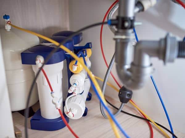 Reverse osmosis system hooked up under sink.