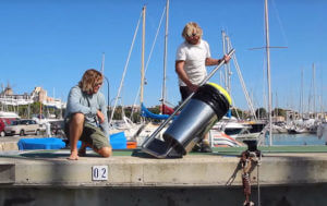 The creators of The Seabin check out their invention before throwing it into the harbor.