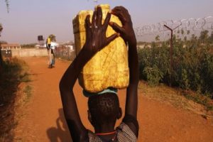 A girl carries water back to her home in an area for displaced Sudanese in the southern Sudanese city of Juba, SudanSpencer Platt/Getty Images