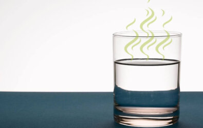 Glass of water with green lines over it, indicating it smells like sulfur