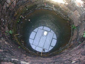 Image looking into a well that is in need of water treatment