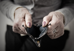 Photo of hands holding open an empty coin purse.