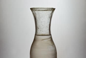 Photo of a pitcher of murky water in need of water purification.