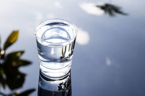 Photo of a glass of water after alkalinizing water treatment.