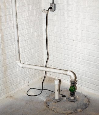 Picture of a sump pump in the basement of a residential home.