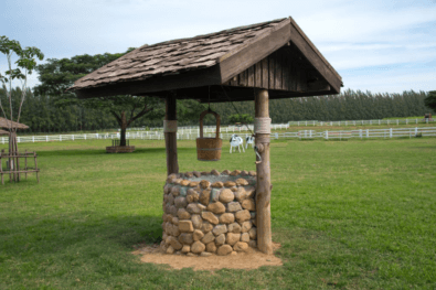 An image of a wooden well for homes with well water systems.