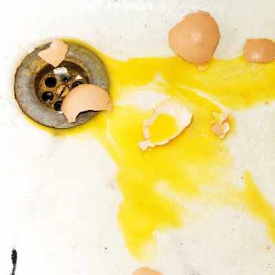 Broken egg in a sink