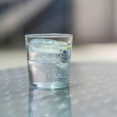 Glass of water that tastes like metal sitting on a counter