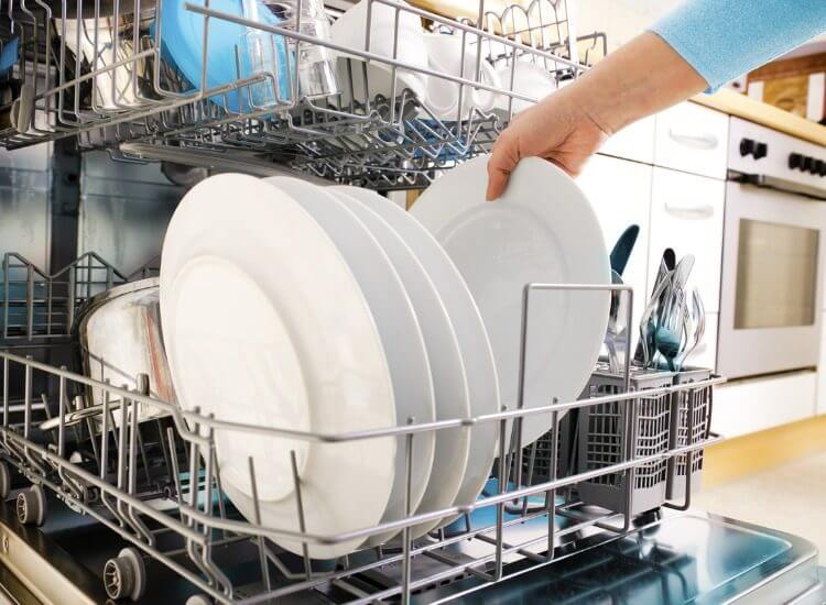 Person removing cloudy dishes from the dishwasher
