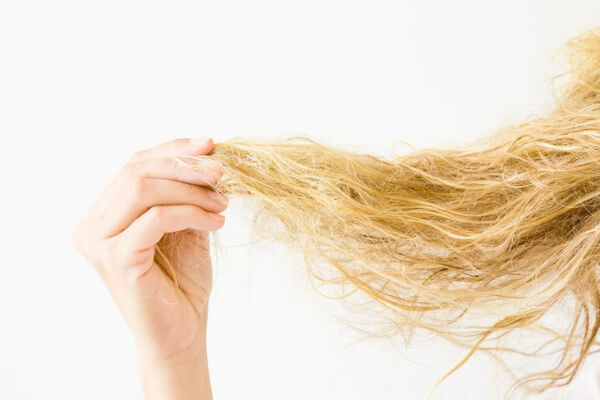 Woman with tangled and frizzy hard water hair