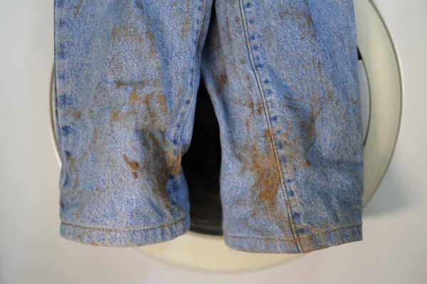 Blue jeans that came out of the washing machine with rust stains on them