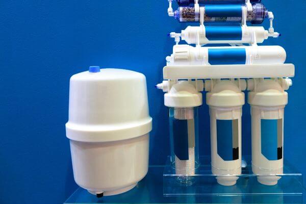 A reverse osmosis system in front of a blue background