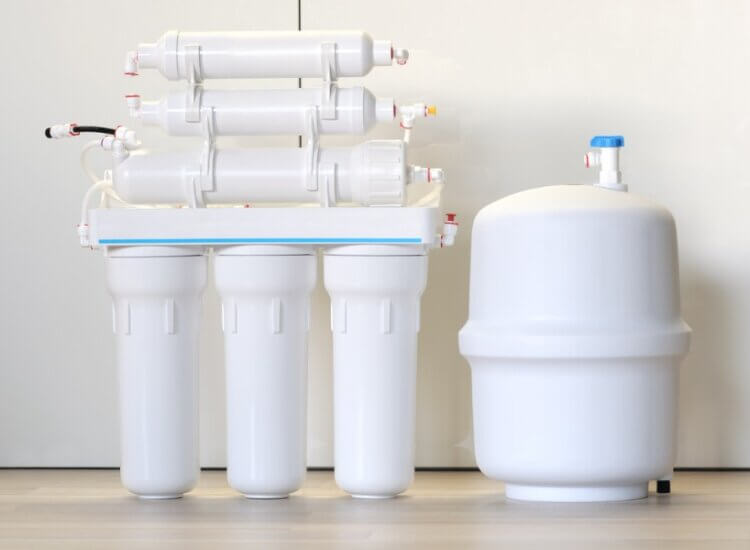 A reverse osmosis system sits on a counter