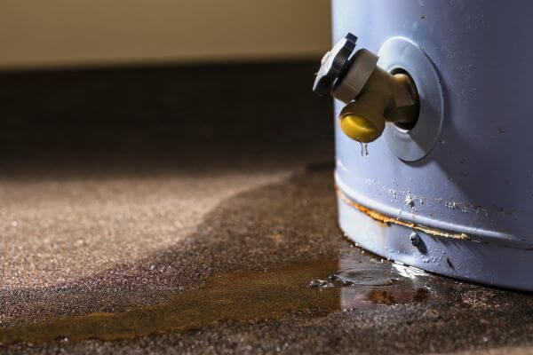 A water heater leaks onto the floor